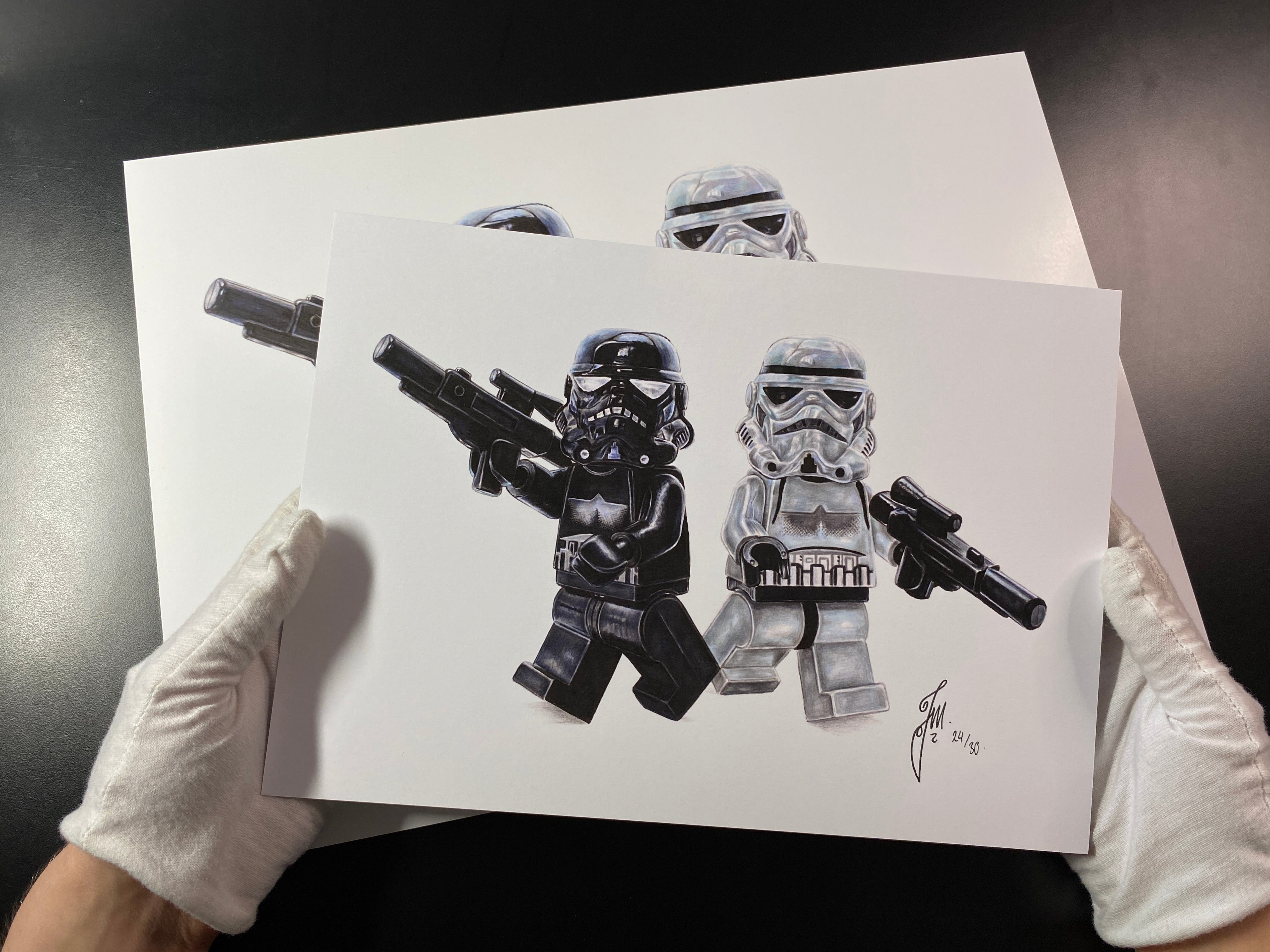 an A3 and A4 print of realistic coloured pencil drawing of 2 lego stormtrooper minifigures