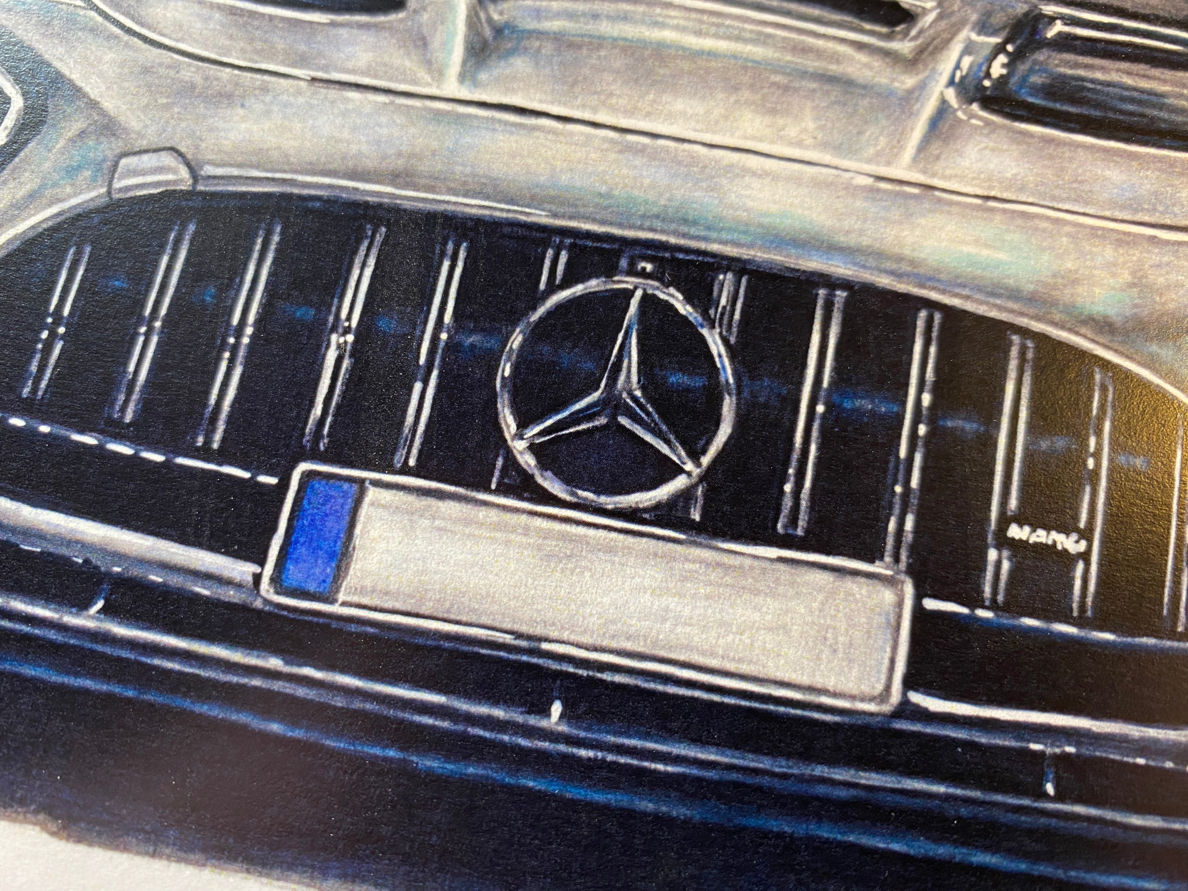 close up of the mercedes logo on my realistic coloured pencil drawing of a silver Mercedes AMG GTR